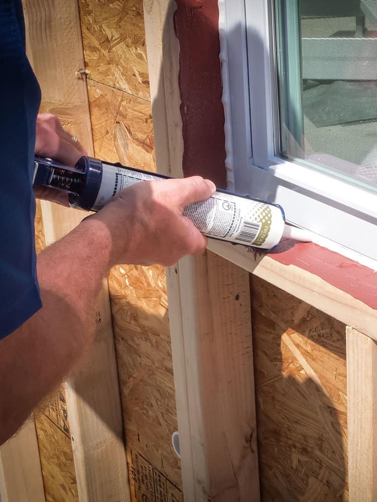 Applying PROSOCO AirDam to window frame exterior