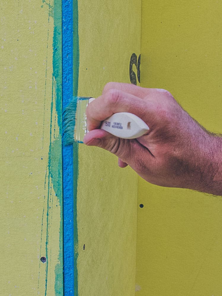 Applying PorousPrep with brush on gypsum board joint